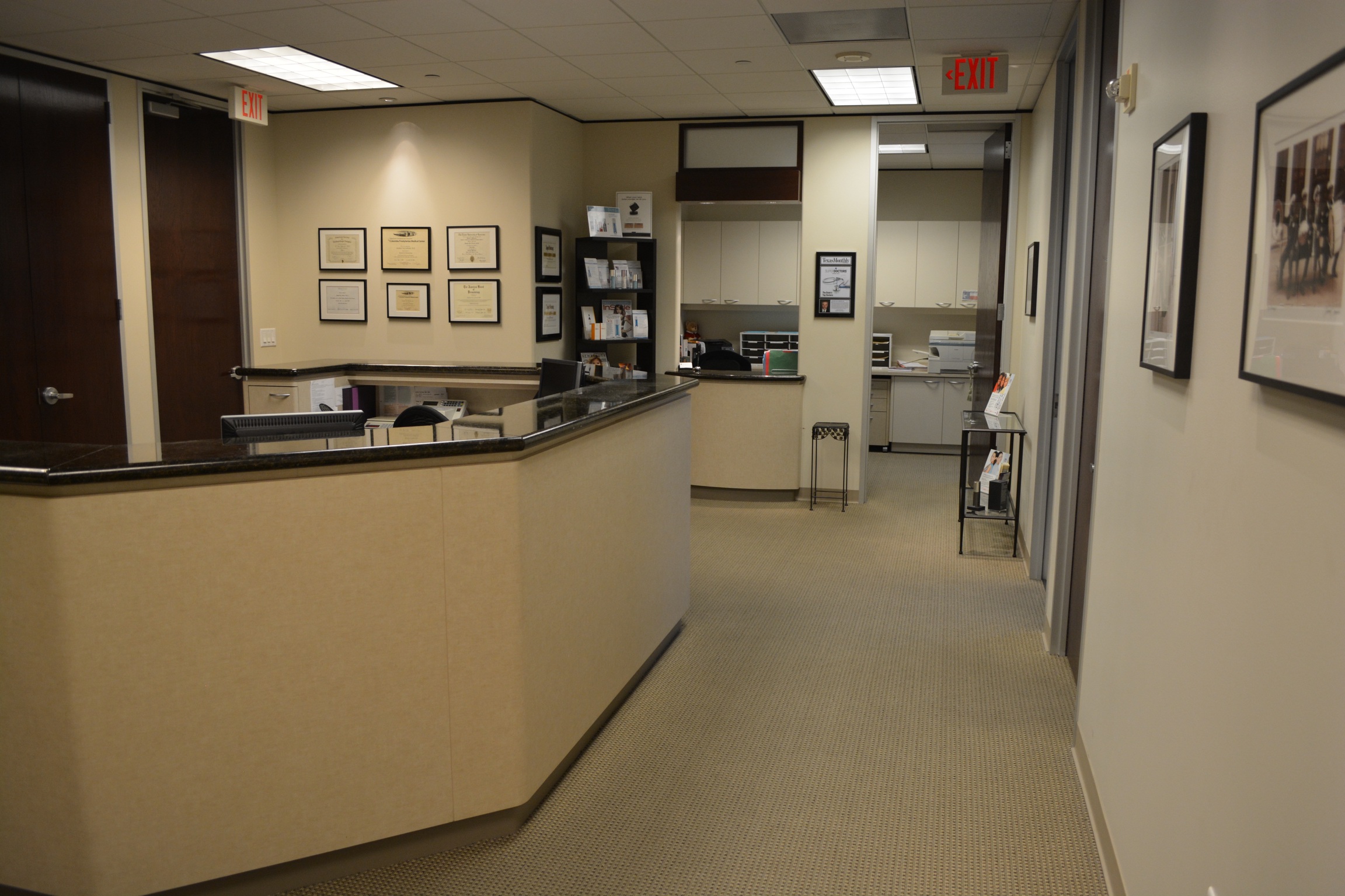 Office interior showing photographs, art and clinical workstation