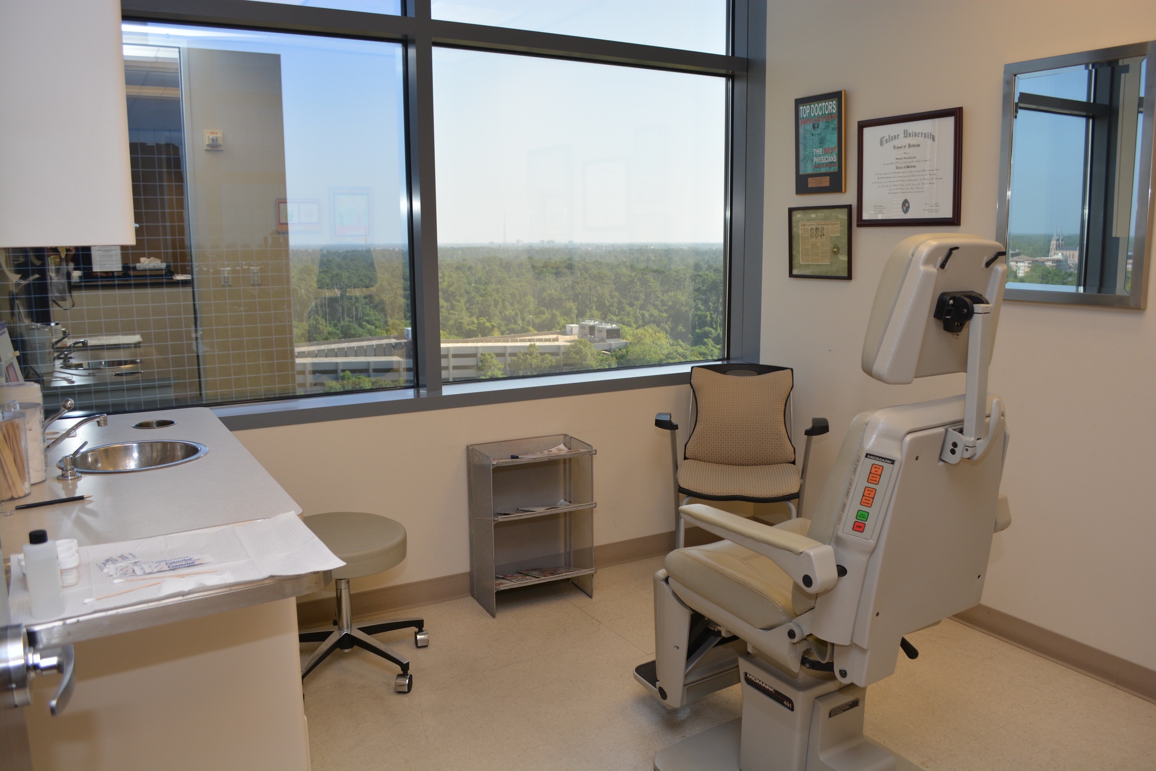 Patient exam room with chairs and dermatology